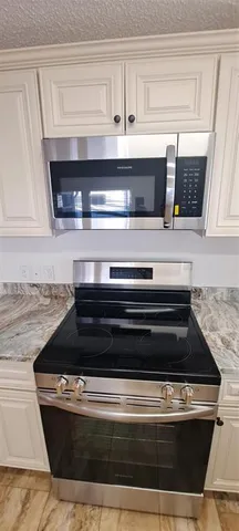 a stove top oven sitting inside of a kitchen
