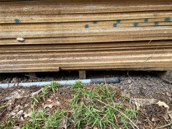 a backyard of a house with barbeque oven and outdoor seating