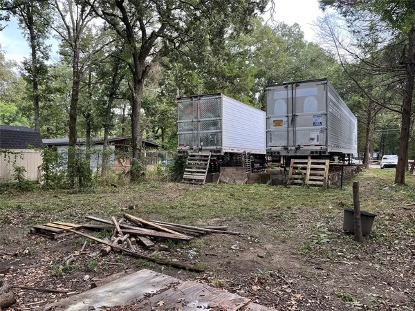 a backyard of a house with barbeque oven and outdoor seating