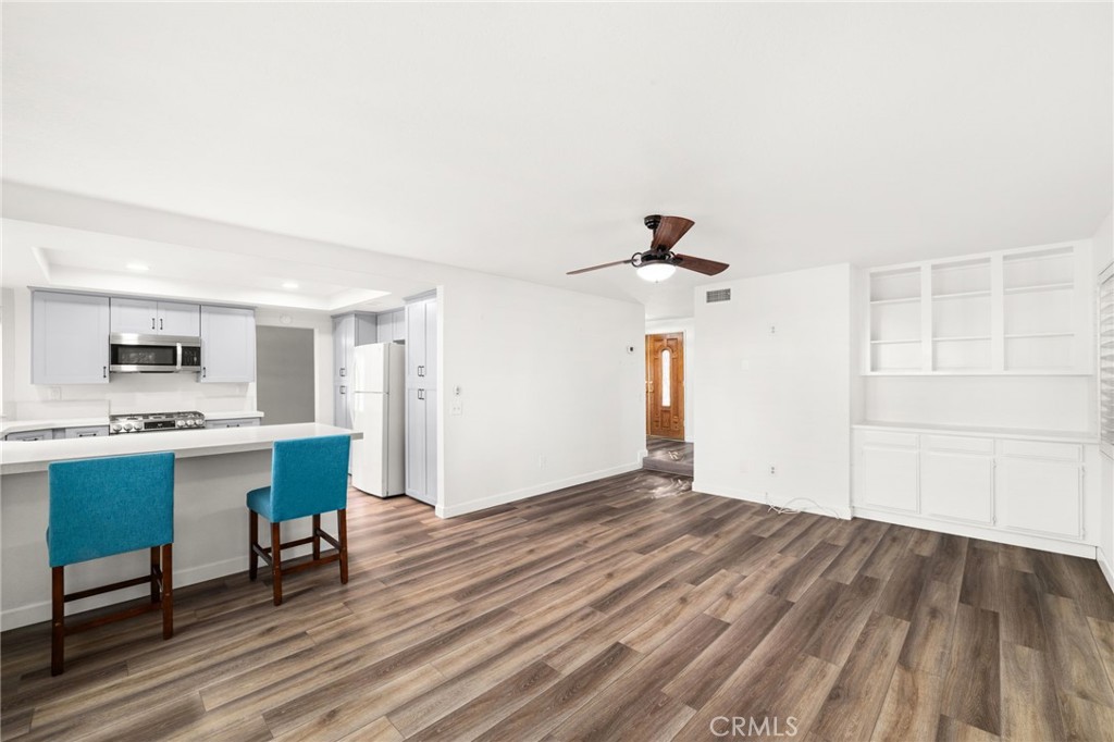 162 Lakeside Avenue Redlands, CA 92373 - Photo 11 of 32 a view of a workspace with wooden floor and a chandelier fan