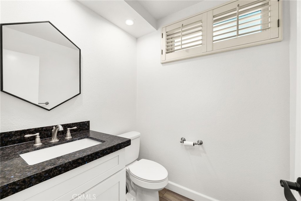 162 Lakeside Avenue Redlands, CA 92373 - Photo 13 of 32 a bathroom with a granite countertop sink and a mirror