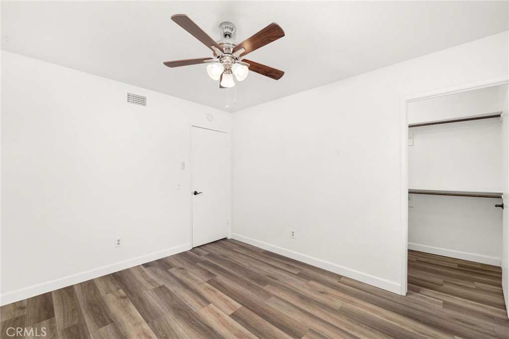 162 Lakeside Avenue Redlands, CA 92373 - Photo 19 of 32 an empty room with wooden floor and ceiling fan