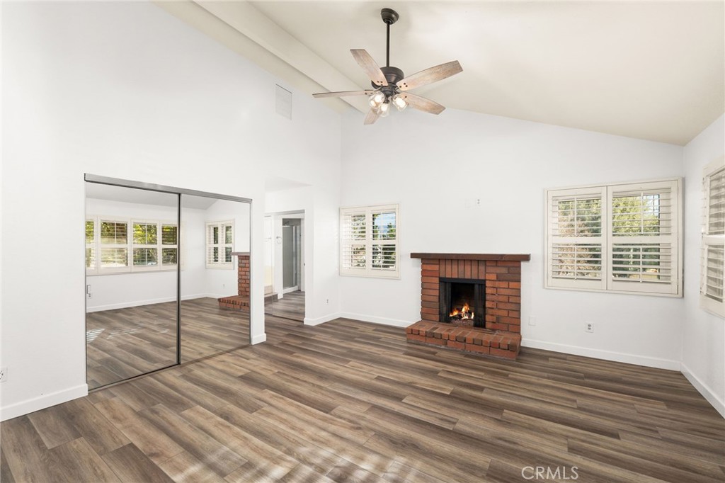 162 Lakeside Avenue Redlands, CA 92373 - Photo 23 of 32 an empty room with fireplace chandelier and windows