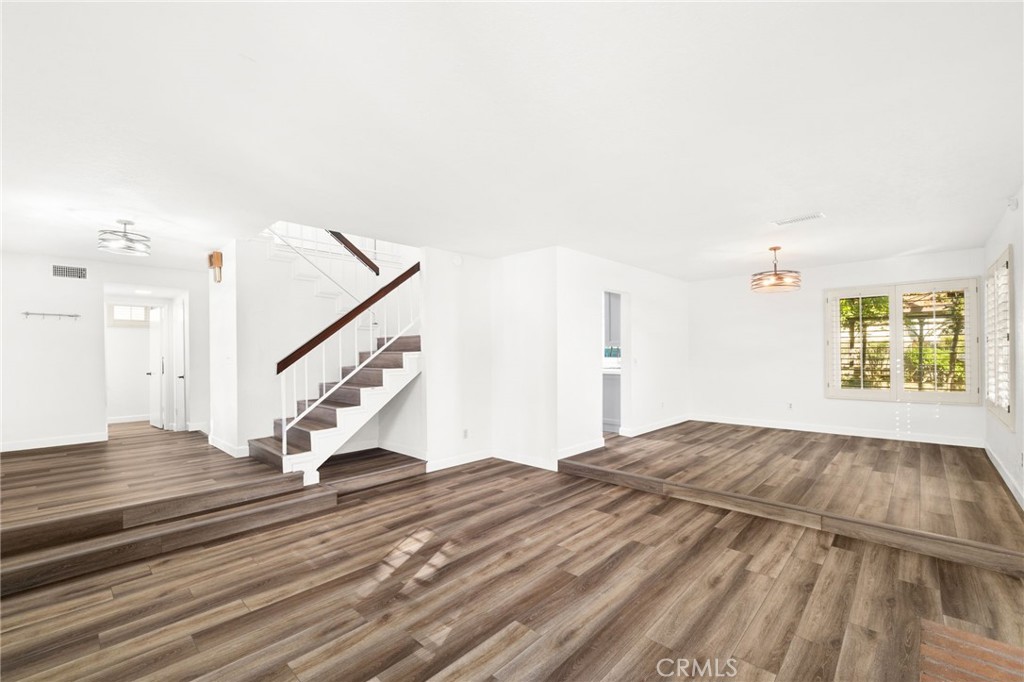 162 Lakeside Avenue Redlands, CA 92373 - Photo 5 of 32 a view of a bedroom with wooden floor and stairs