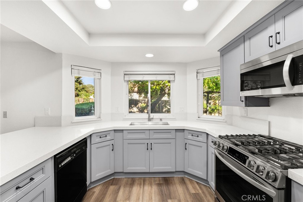 162 Lakeside Avenue Redlands, CA 92373 - Photo 8 of 32 a kitchen with stainless steel appliances a sink cabinets and a window