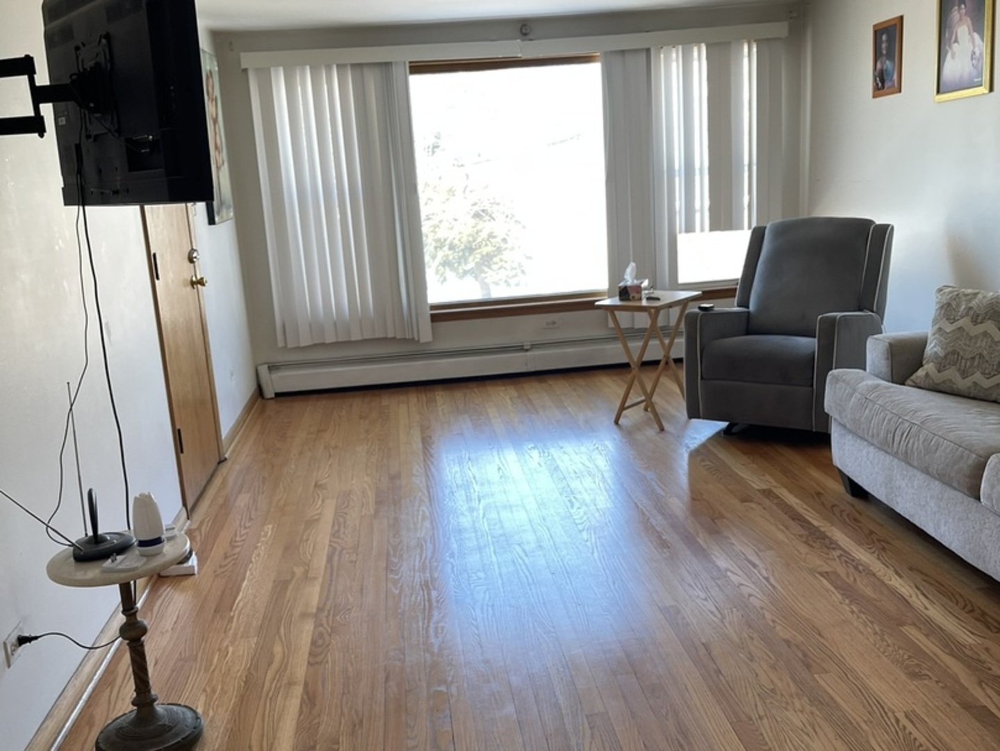 5325 West 53rd Place Chicago, IL 60638 - Photo 12 of 25 a living room with hard wood floors and a window