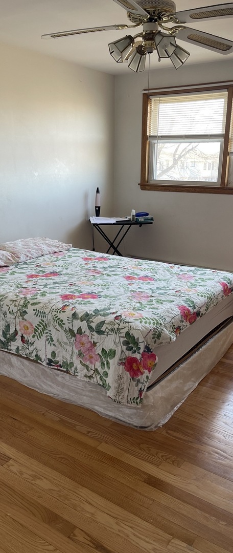 5325 West 53rd Place Chicago, IL 60638 - Photo 13 of 25 a bed sitting in a bedroom next to a window
