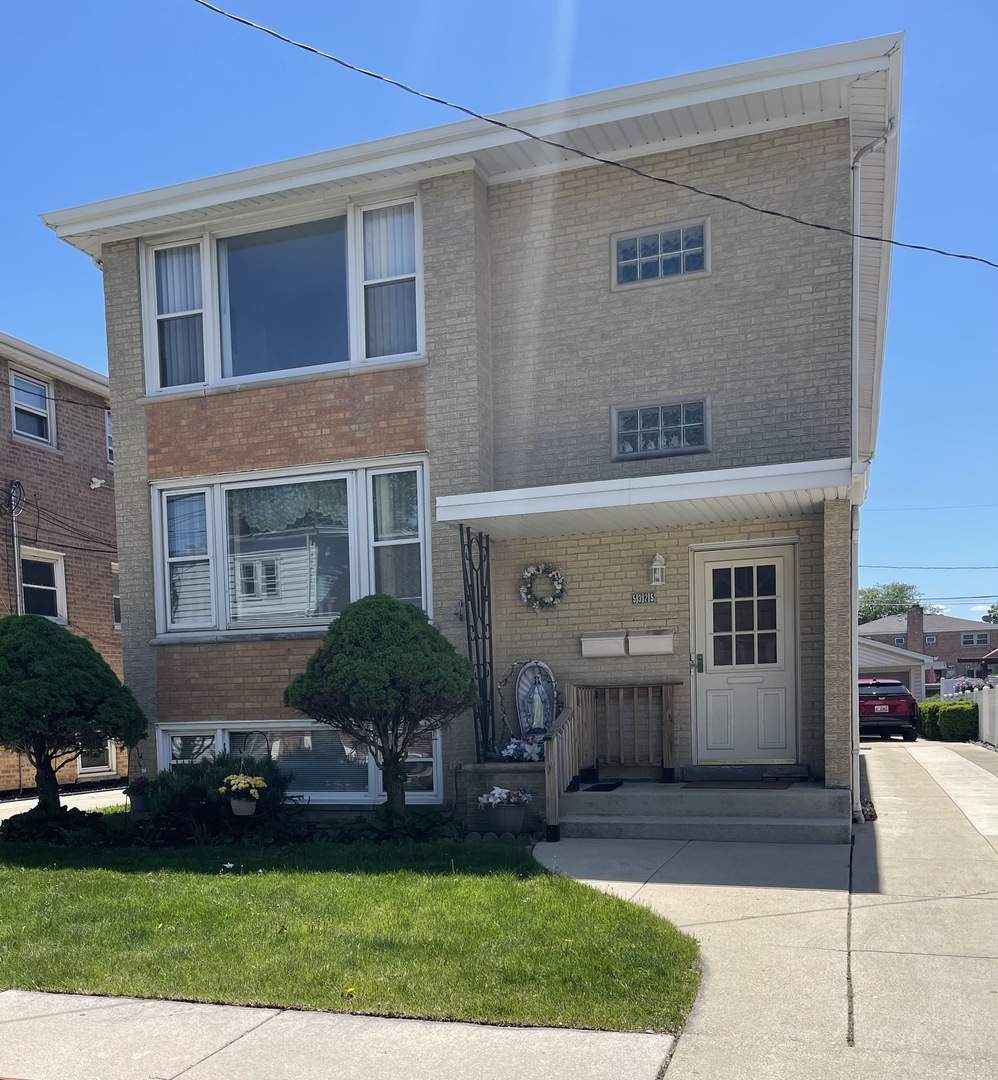 5325 West 53rd Place Chicago, IL 60638 - Photo 2 of 25 a front view of a house with garden