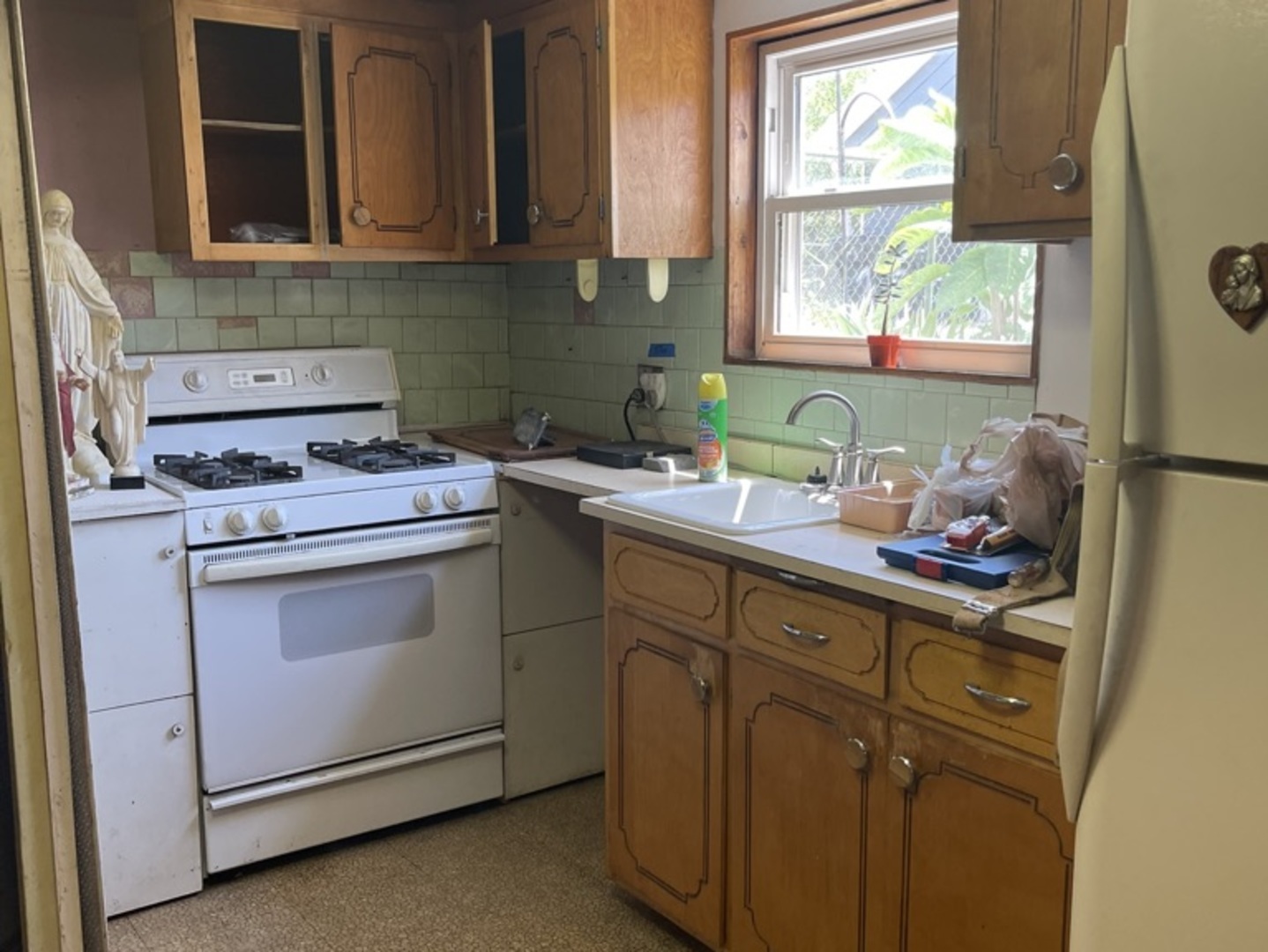 5325 West 53rd Place Chicago, IL 60638 - Photo 22 of 25 a kitchen with a sink cabinets appliances and a window