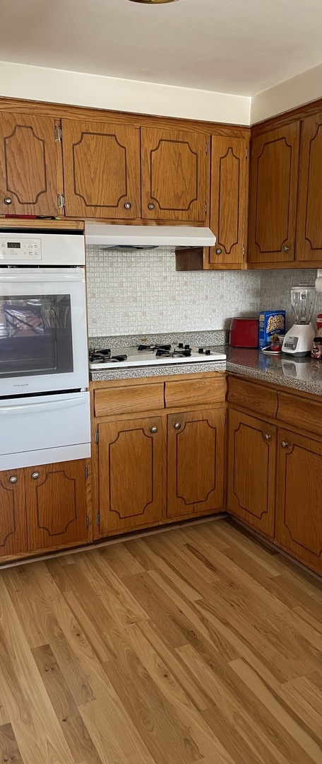 5325 West 53rd Place Chicago, IL 60638 - Photo 10 of 25 a kitchen with stainless steel appliances granite countertop a stove a sink and a microwave
