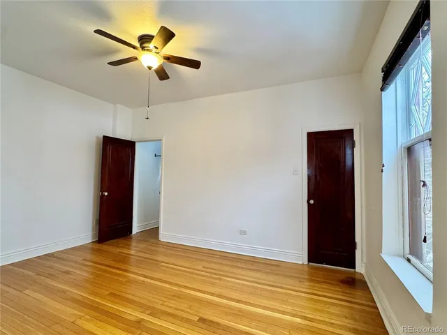 a view of a room with a ceiling fan
