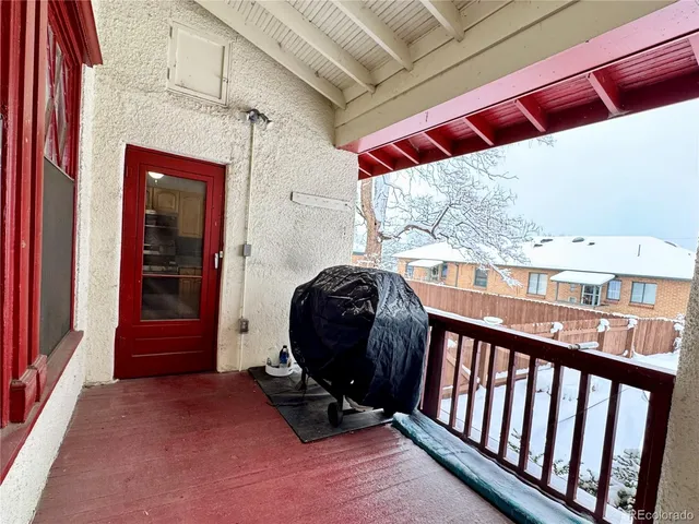 a balcony with wooden floor and fence