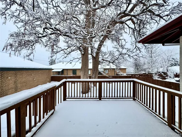 a backyard of a house with barbeque oven and outdoor seating