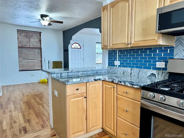 a kitchen with granite countertop cabinets stainless steel appliances a sink and a counter top space