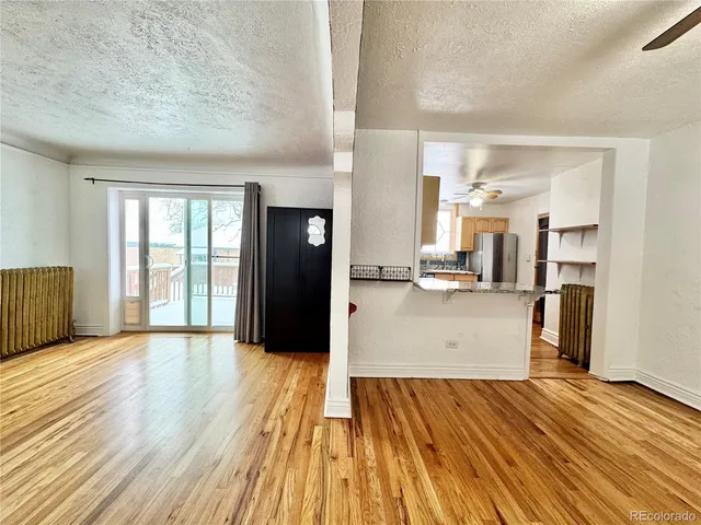 a view of kitchen with cabinets and wooden floor