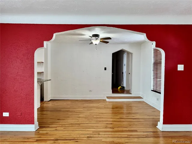 a view of a room with wooden floor