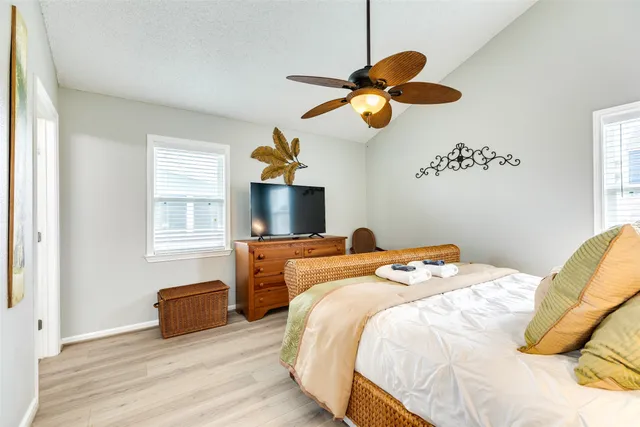 a bedroom with a bed and a chandelier