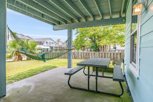 a view of a porch with furniture and a yard