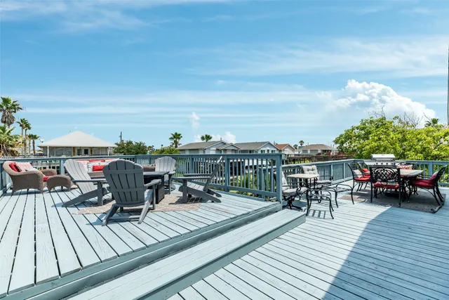 a view of a house with a patio and a yard