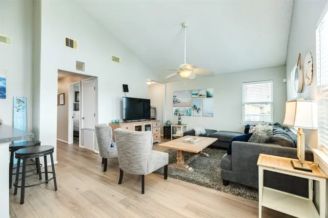 a living room with furniture a flat screen tv and a window
