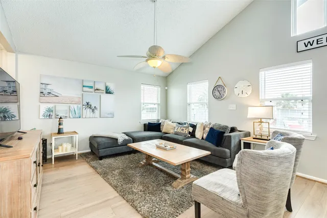 a living room with fireplace furniture and a large window