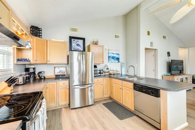 a kitchen with stainless steel appliances a refrigerator sink and cabinets