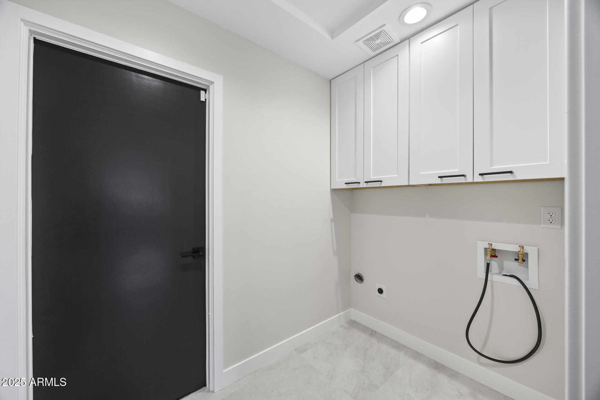 4059 East Cholla Street Phoenix, AZ 85028 - Photo 38 of 70 a room with white cabinets and a black door