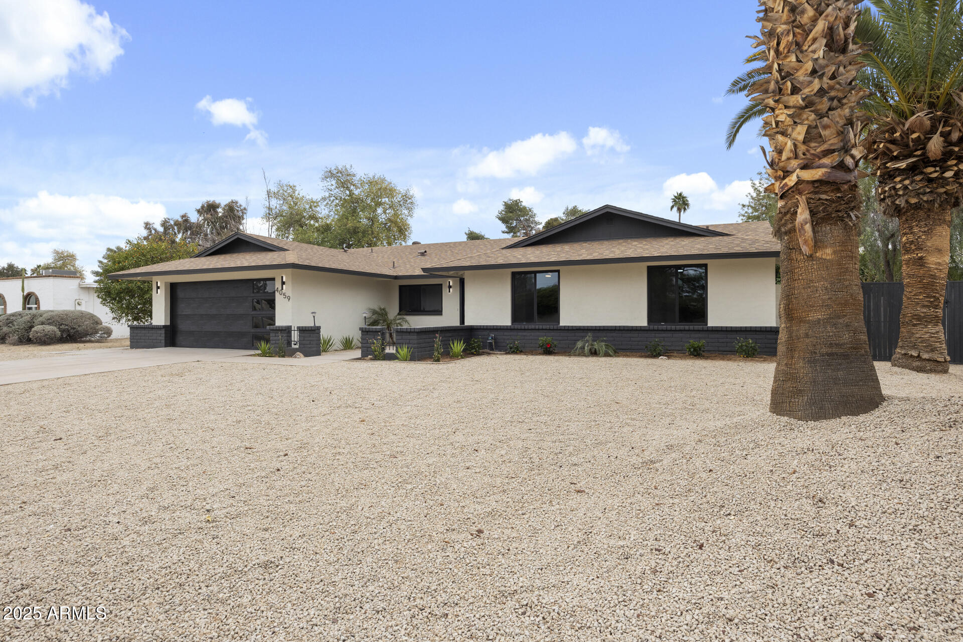 4059 East Cholla Street Phoenix, AZ 85028 - Photo 3 of 70 a front view of a house with a yard and garage