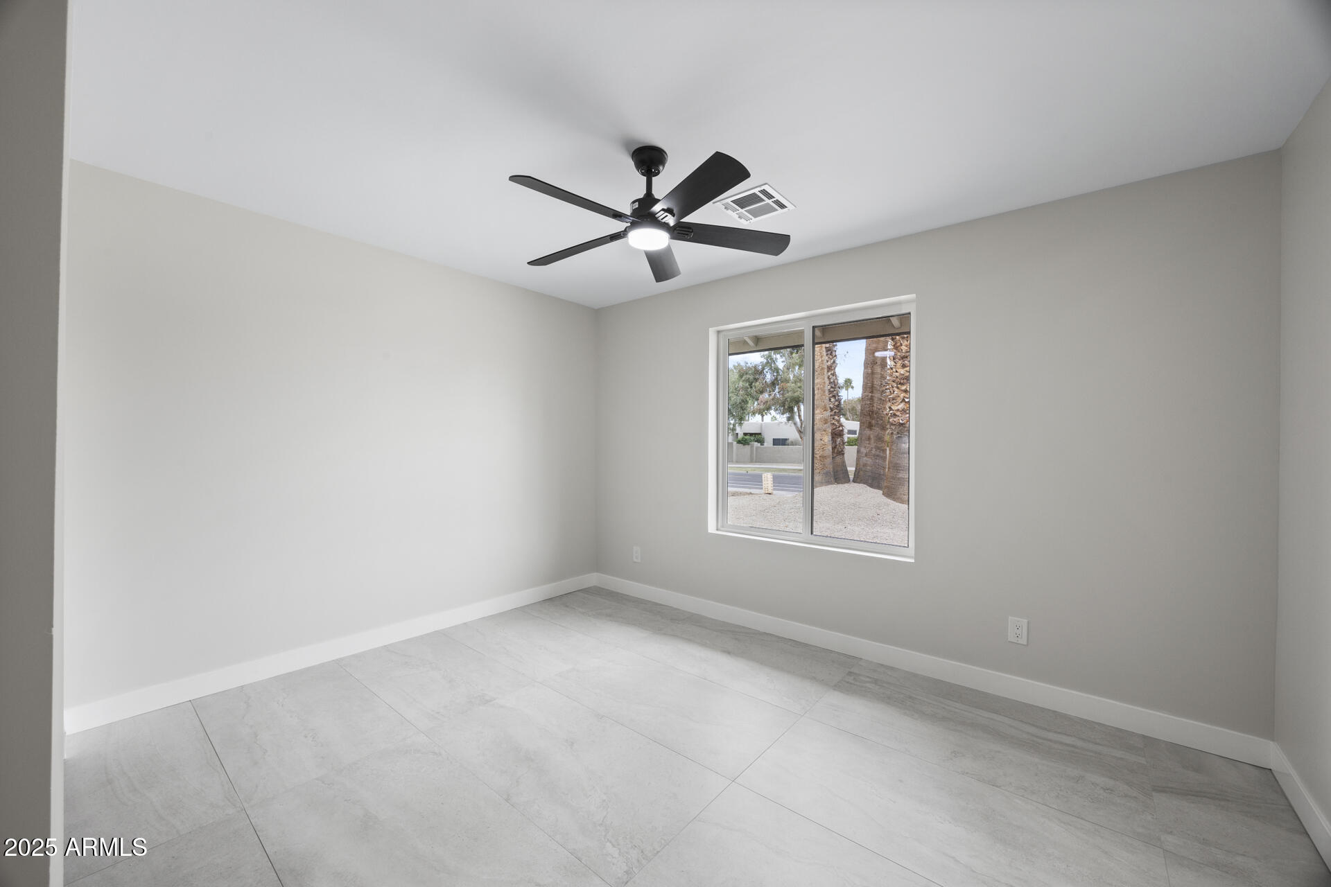 4059 East Cholla Street Phoenix, AZ 85028 - Photo 47 of 70 an empty room with a window and a fan