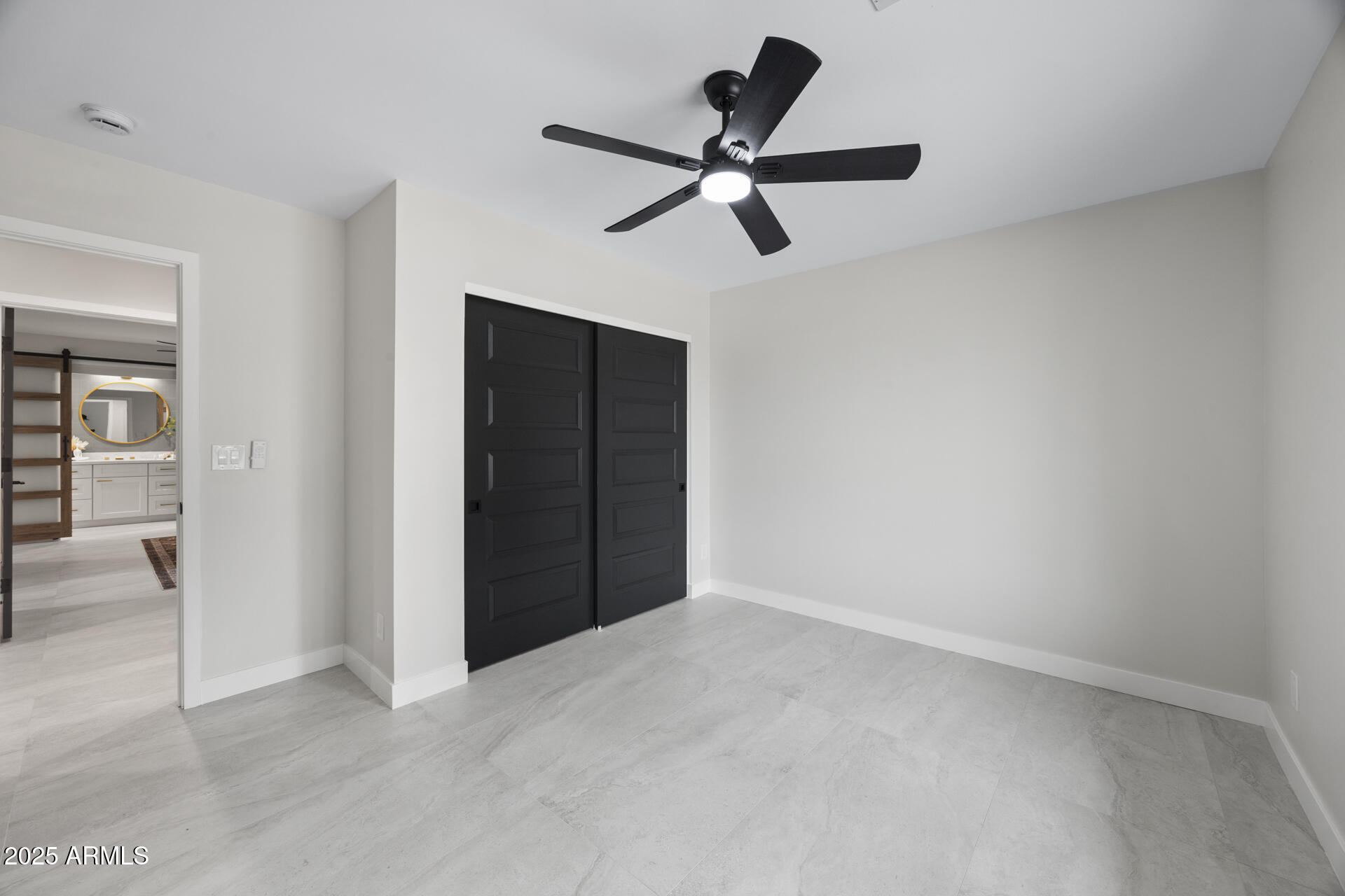 4059 East Cholla Street Phoenix, AZ 85028 - Photo 48 of 70 a view of a livingroom with a ceiling fan and closet