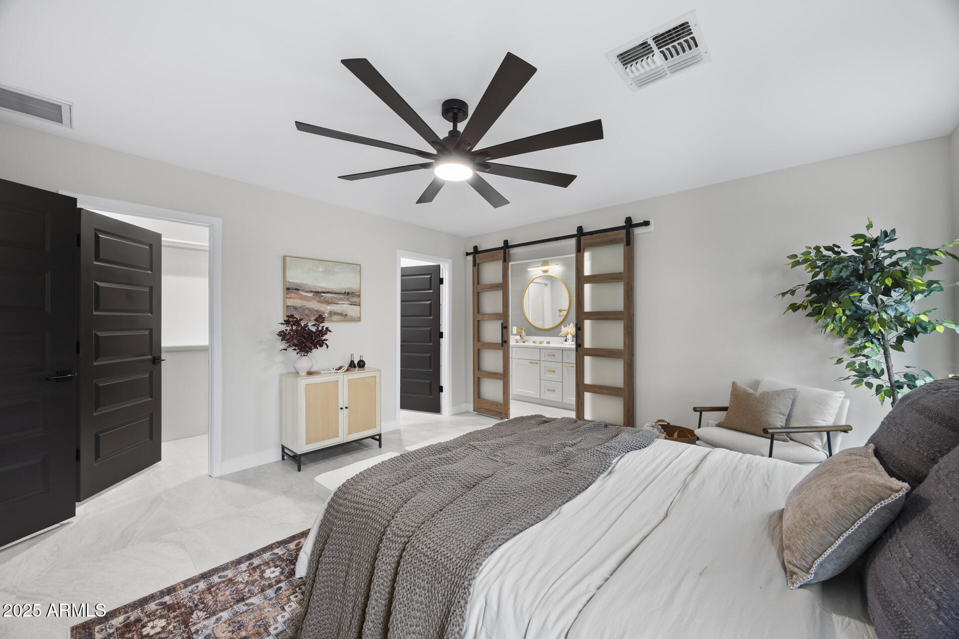 4059 East Cholla Street Phoenix, AZ 85028 - Photo 52 of 70 a spacious bedroom with a bed and a chandelier
