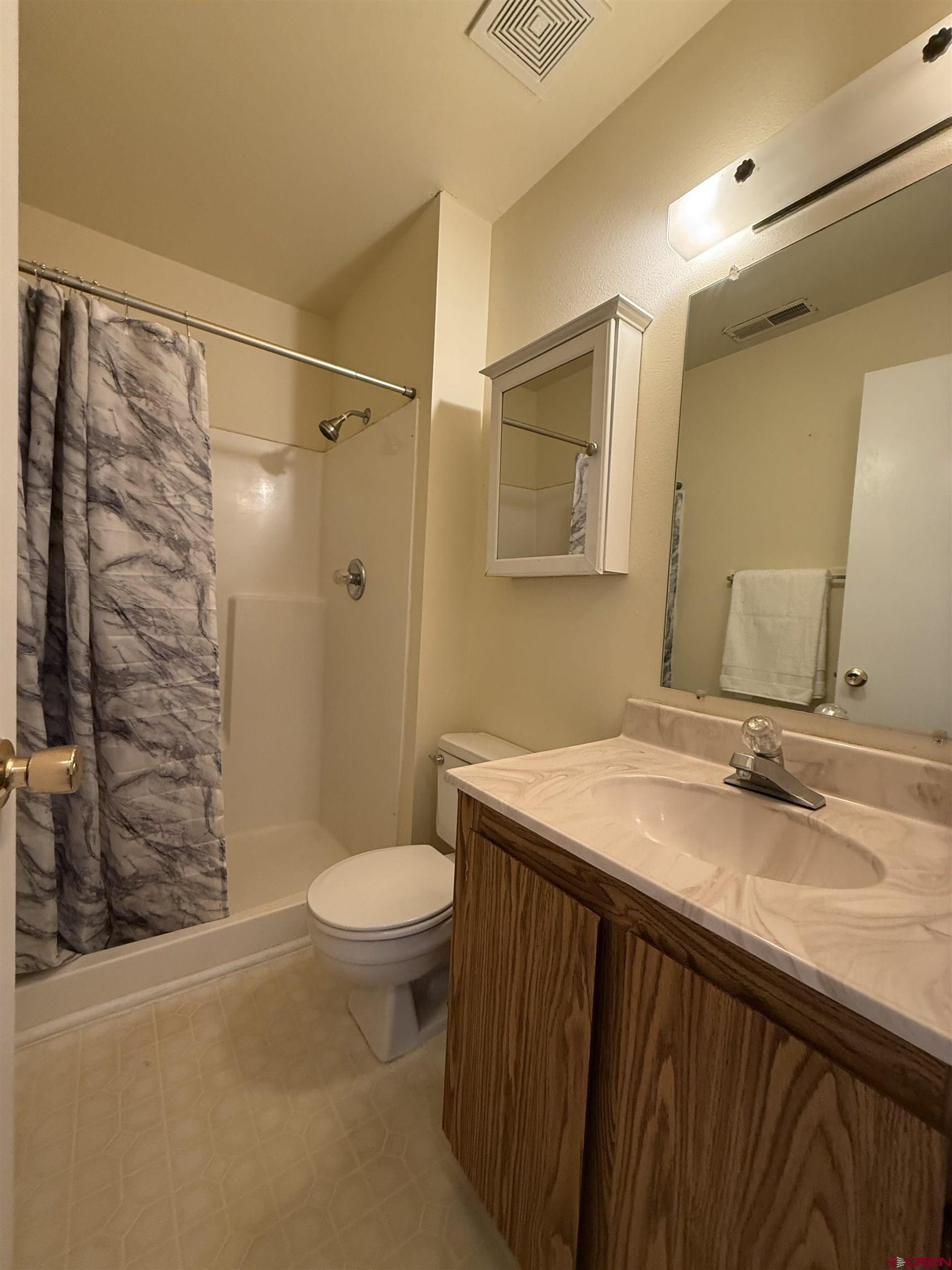 1200 Florida Road, Unit 52 Durango, CO 81301 - Photo 18 of 29 a bathroom with a granite countertop sink toilet and shower