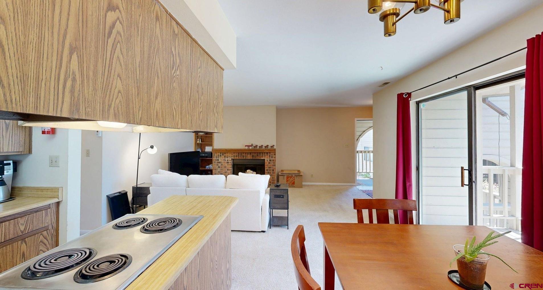 1200 Florida Road, Unit 52 Durango, CO 81301 - Photo 6 of 29 a dining room with furniture a rug and a refrigerator