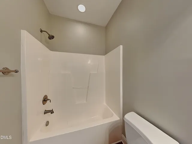 a bathroom with a bathtub and toilet