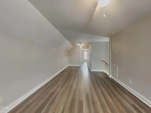 a view of wooden floor and staircase in a room