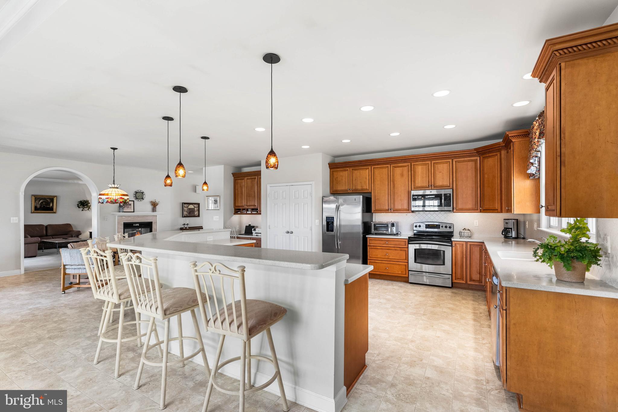 15507 Manor Road Monkton, MD 21111 - Photo 15 of 31 a kitchen with stainless steel appliances kitchen island granite countertop a stove top oven a sink a dining table and chairs with wooden floor