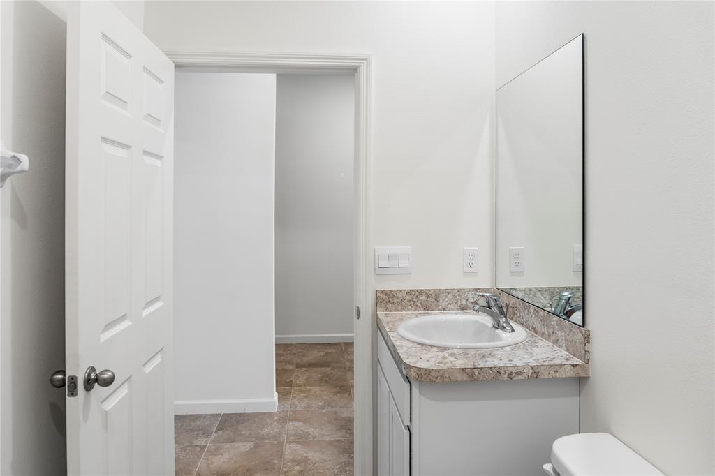 2025 Amazon Way Vero Beach, FL 32962 - Photo 18 of 33 a bathroom with a granite countertop sink and a mirror