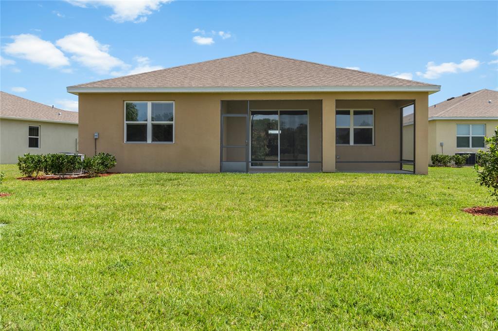 2025 Amazon Way Vero Beach, FL 32962 - Photo 26 of 33 a view of a house with a yard and plants