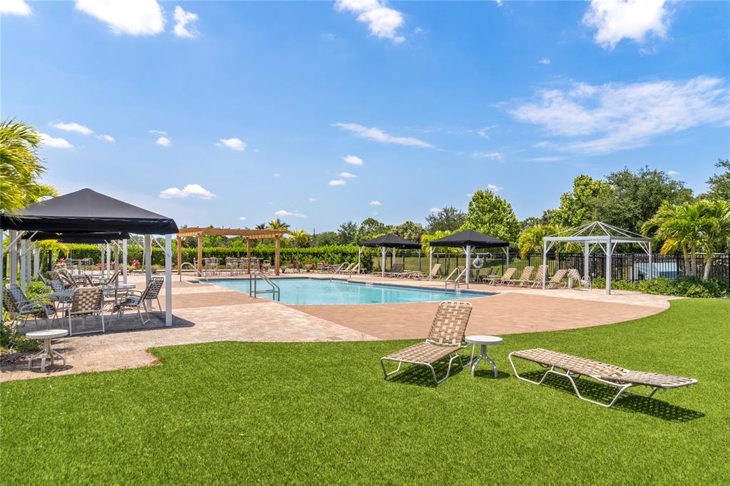 2025 Amazon Way Vero Beach, FL 32962 - Photo 29 of 33 a view of a swimming pool with lawn chairs and a big yard