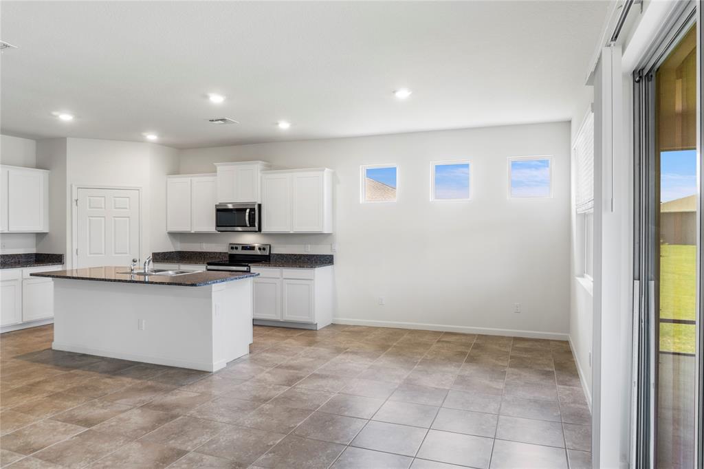 2025 Amazon Way Vero Beach, FL 32962 - Photo 6 of 33 a kitchen with stainless steel appliances granite countertop a refrigerator and a sink