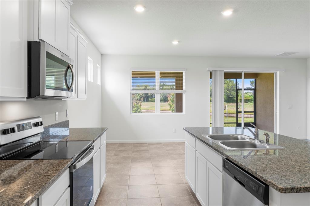 2025 Amazon Way Vero Beach, FL 32962 - Photo 9 of 33 a kitchen with granite countertop a sink and a stove