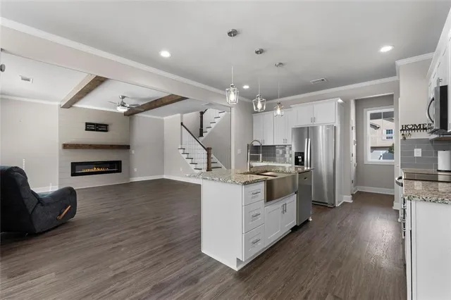 a kitchen with stainless steel appliances a refrigerator and a stove top oven