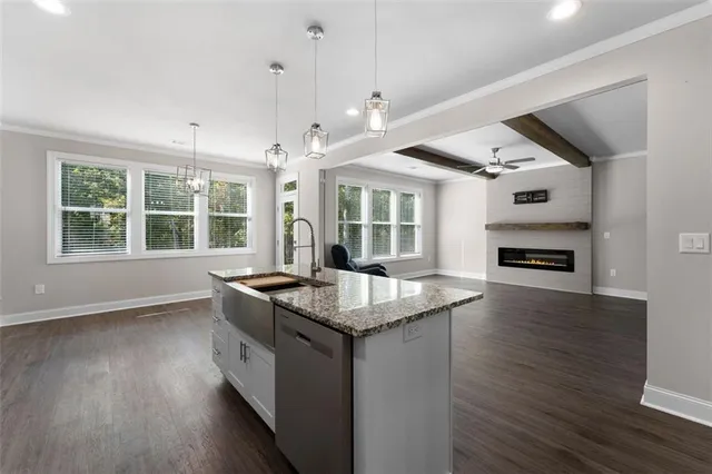 a kitchen with granite countertop a stove and a wooden floors