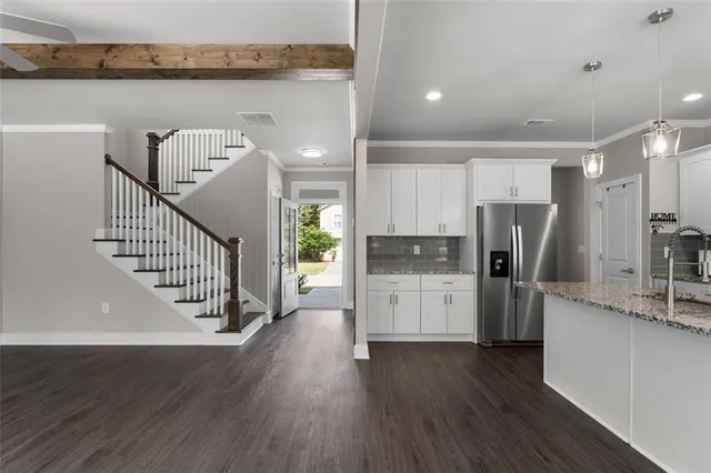 a kitchen with refrigerator and cabinets