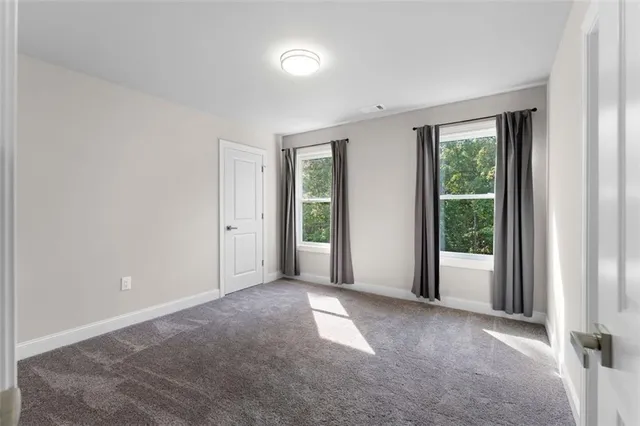 a view of a big room with windows and closet