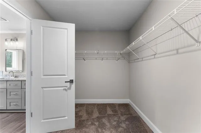 a view of walk in closet with white walls