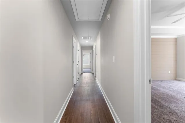 a view of a hallway with wooden floor