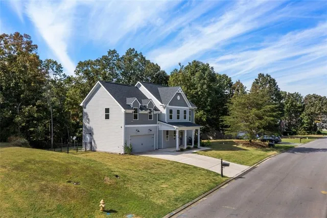 a view of house with outdoor space and swimming pool