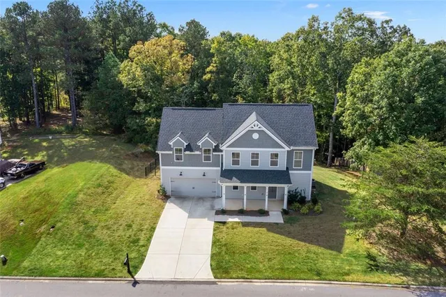 an aerial view of a house with a yard