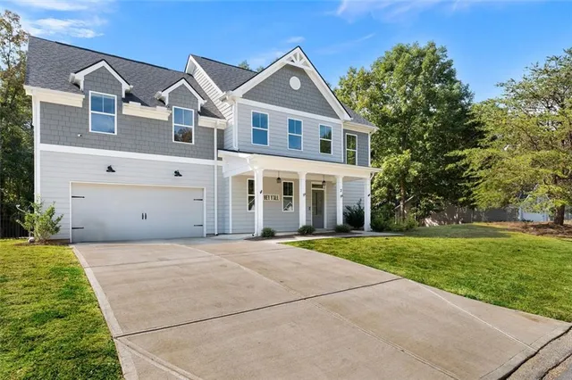 a front view of a house with a yard